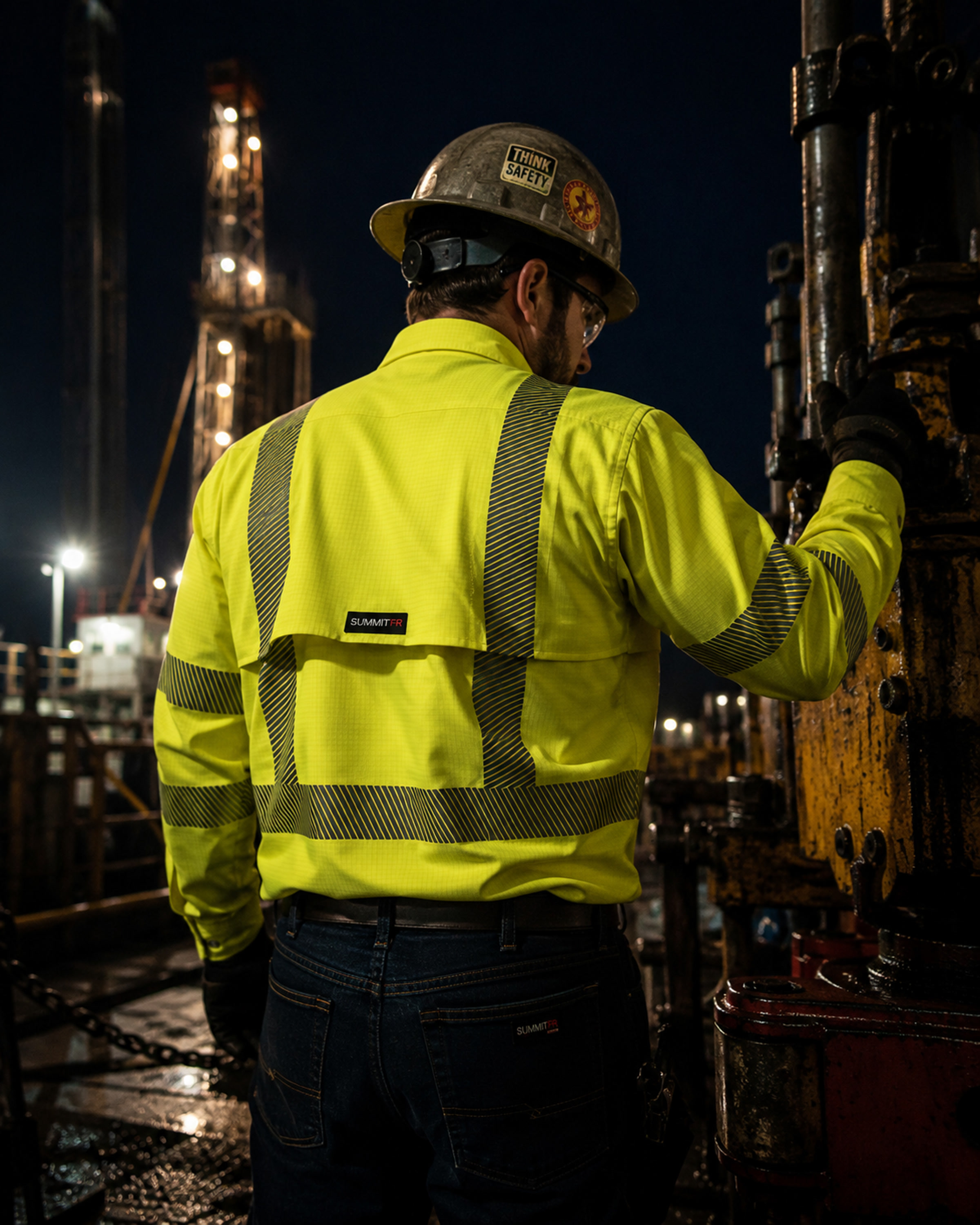 Worker in a Summit Breeze® FR vented hi-vis shirt — back view showing reflective striping
